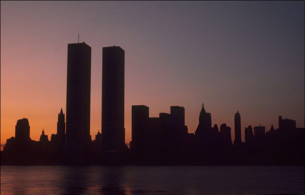 Silhouette of the Twin Towers and New York City skyline at sunset.